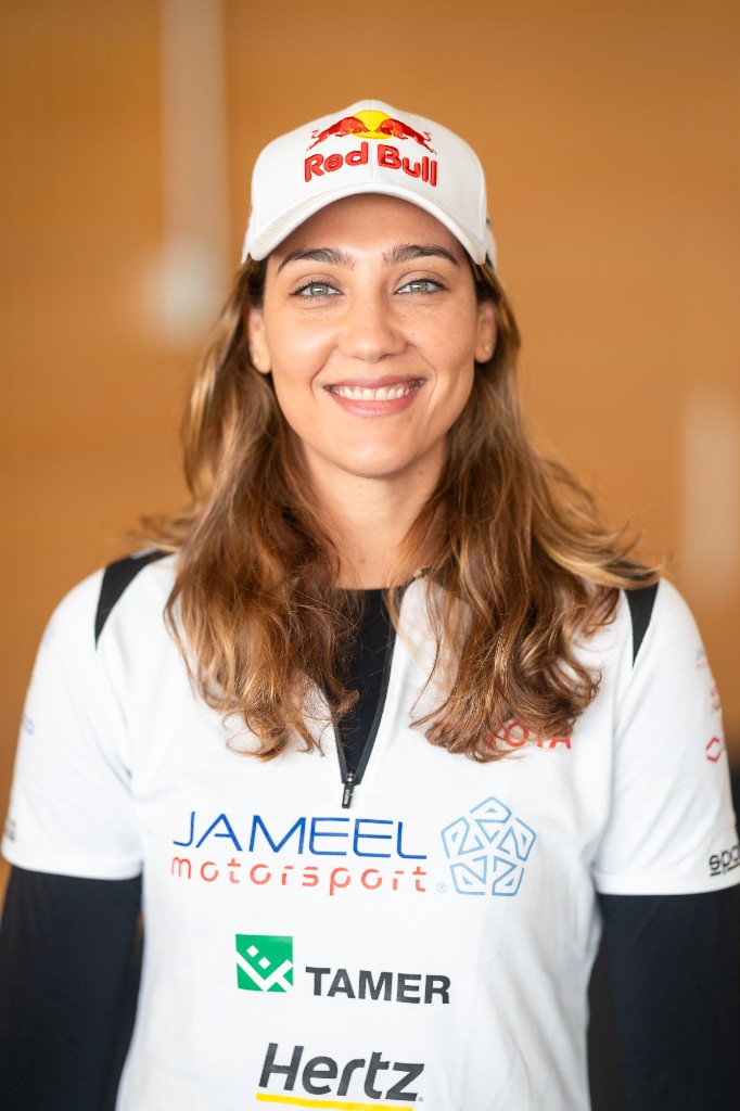 Dania Akeel in team racing gear and cap